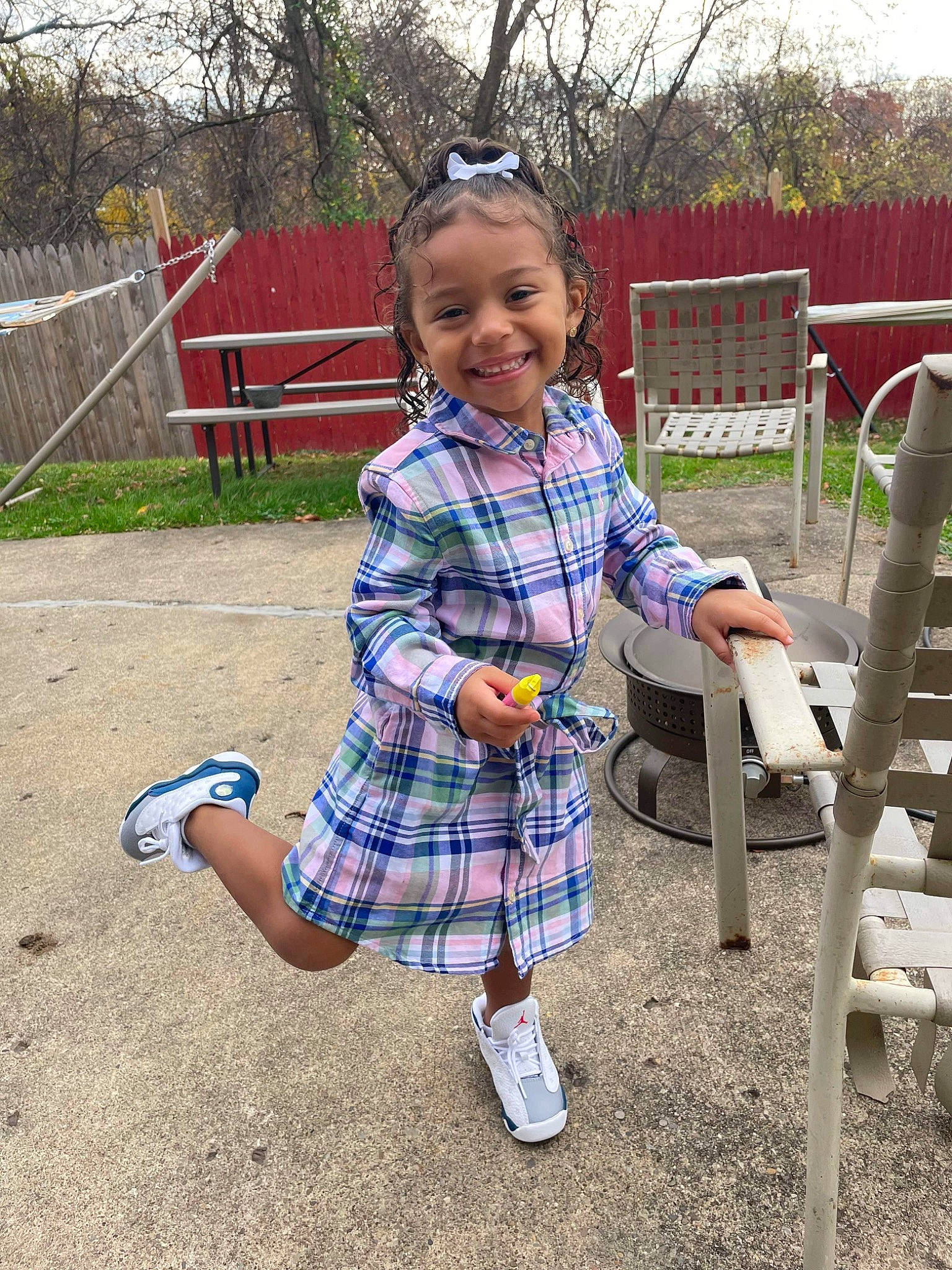 Milani is registered to the contest to win money with this photo: baby_toddler_clothing, chair, child, fun, grass, happy, joy, leisure, outdoor_furniture, pattern, person, plaid, plant, public_space, recreation, smile, sneakers, sunglasses, tartan, toddler