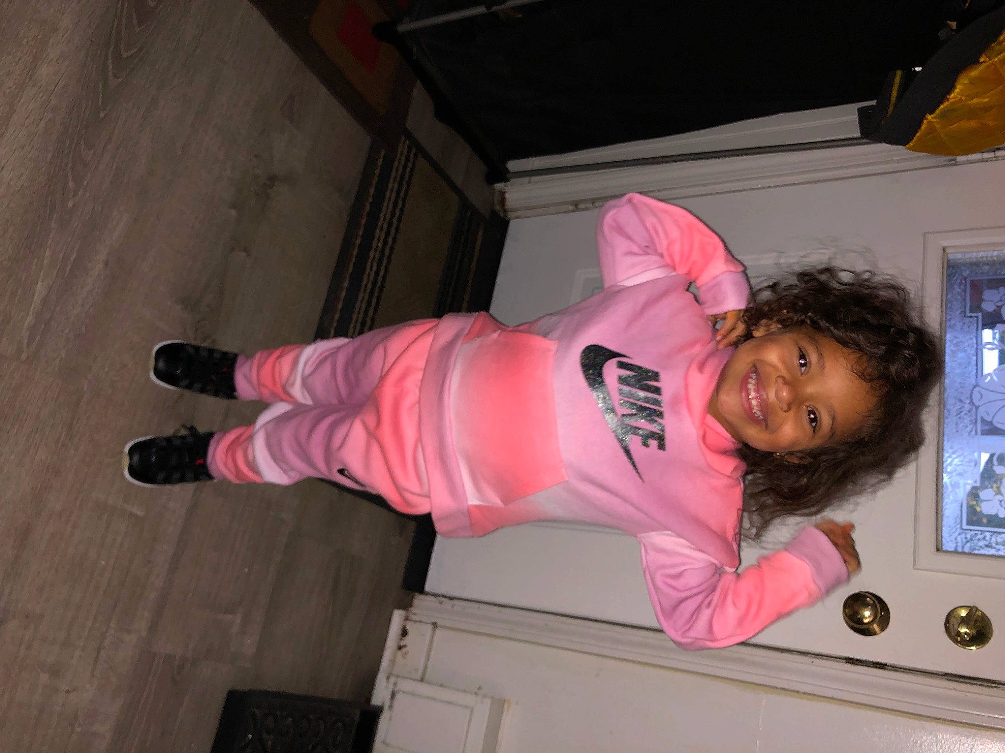 Milani is registered to the contest to win money with this photo: baby_toddler_clothing, child, flooring, fun, happy, hardwood, joy, magenta, person, pink, sleeve, smile, toddler, wood
