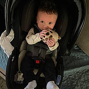 Bryton joined the competition — help win amazing prizes! baby, infant, car_seat, toy, teether, pacifier, socks, seatbelt, hands, wide_eyes, portrait, indoor, blanket, clothing, cushion, comforter, cute, holding_toy, grasping, looking_at_camera