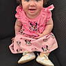 baby, chair, child, clothing, curly_hair, cute, dress, eyes, fashion, happy, indoor, infant, minnie_mouse, person, pink, portrait, shoes, sitting, smile, young_child