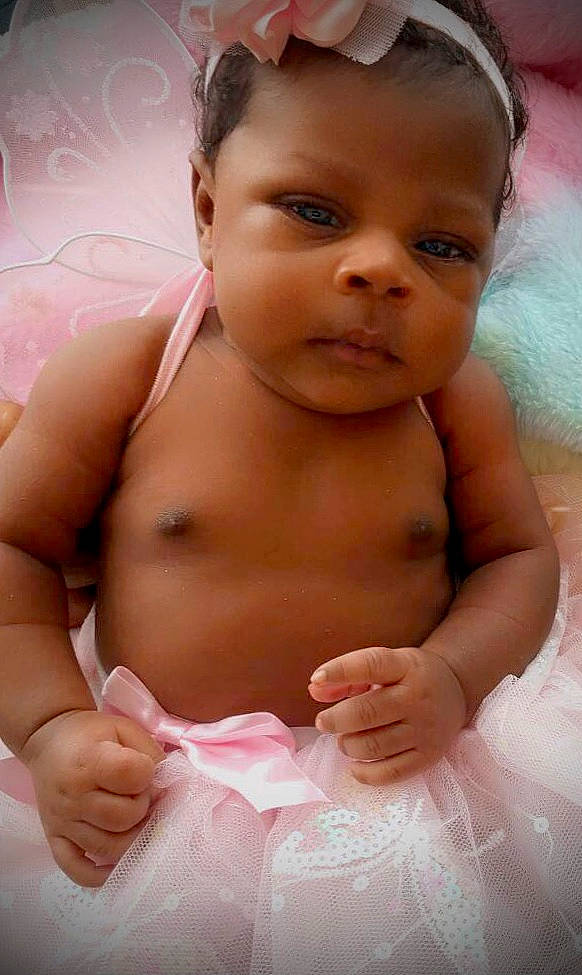 Tiari is registered to the contest to win money with this photo: baby, cheek, ear, eye, eyebrow, eyelash, face, forehead, gesture, hand, happy, lip, mouth, muscle, neck, nose, person, pink, skin, smile