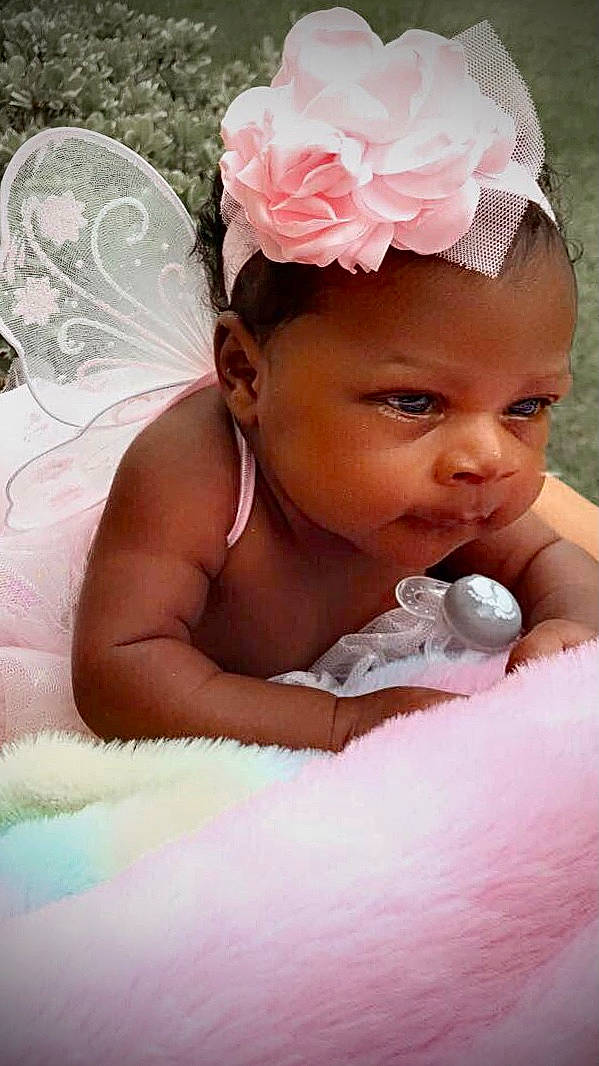 Tiari joined the competition — help win amazing prizes! baby, baby_sleeping, baby_toddler_clothing, cap, child, comfort, eyebrow, hair_accessory, happy, headband, headgear, headpiece, headwear, jewellery, lip, person, petal, pink, skin, smile