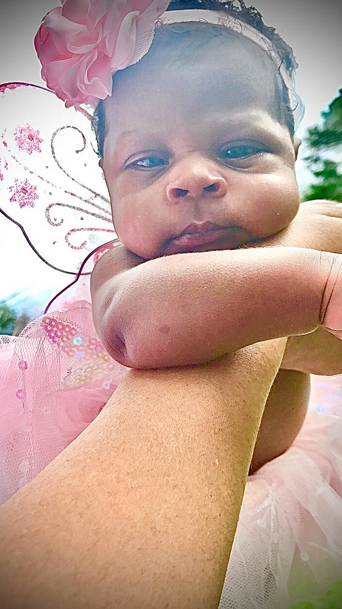 Tiari joined the competition — help win amazing prizes! baby, black_hair, chest, eye, eyebrow, eyelash, face, finger, gesture, grass, happy, head, human_body, lip, mouth, neck, people_in_nature, person, shoulder, skin