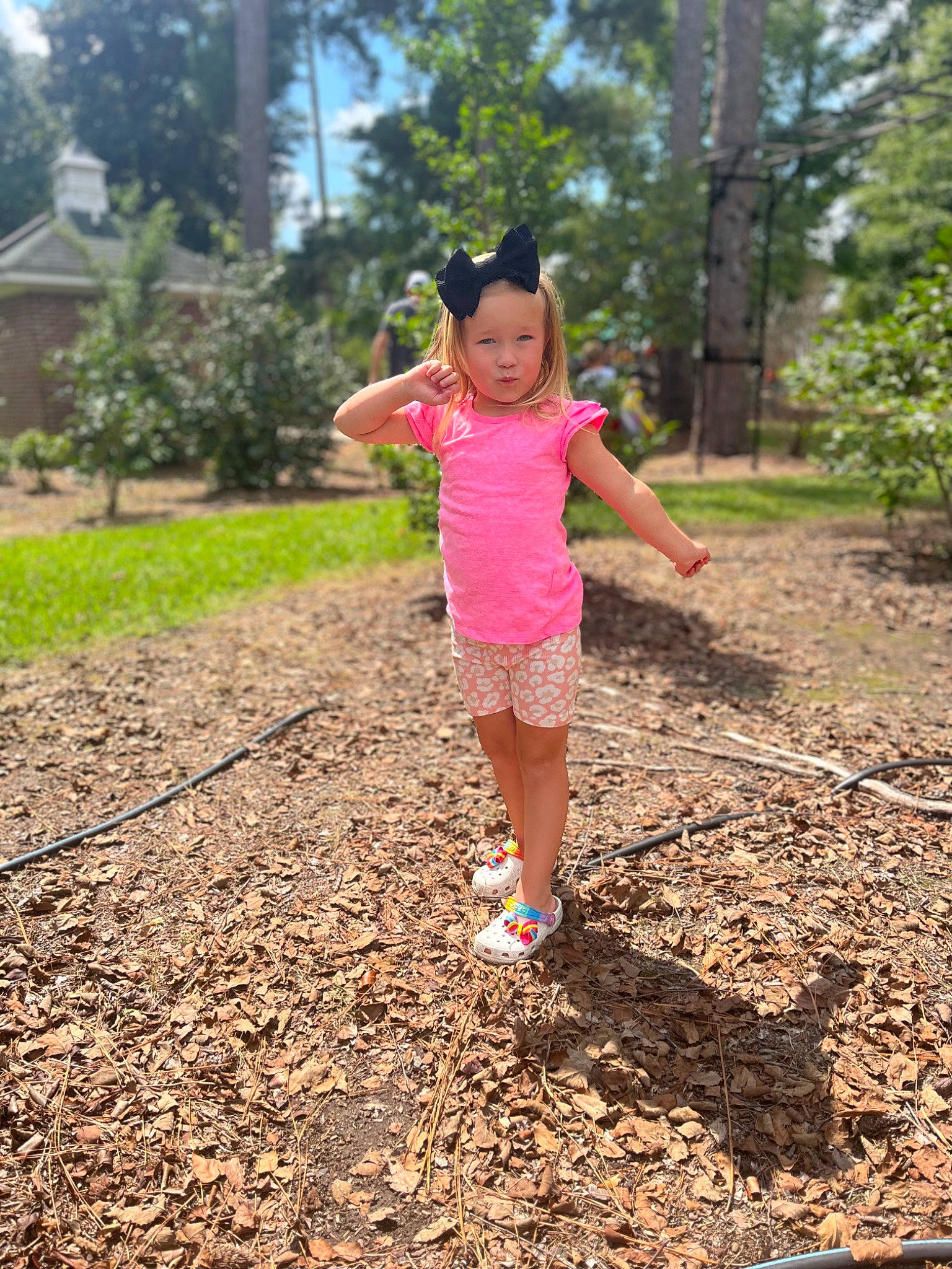 Kinley is registered to the contest to win money with this photo: asphalt, forest, garden, grass, happy, headwear, landscape, leisure, magenta, people_in_nature, person, plant, recreation, road, rural_area, shorts, soil, t_shirt, toddler, trail