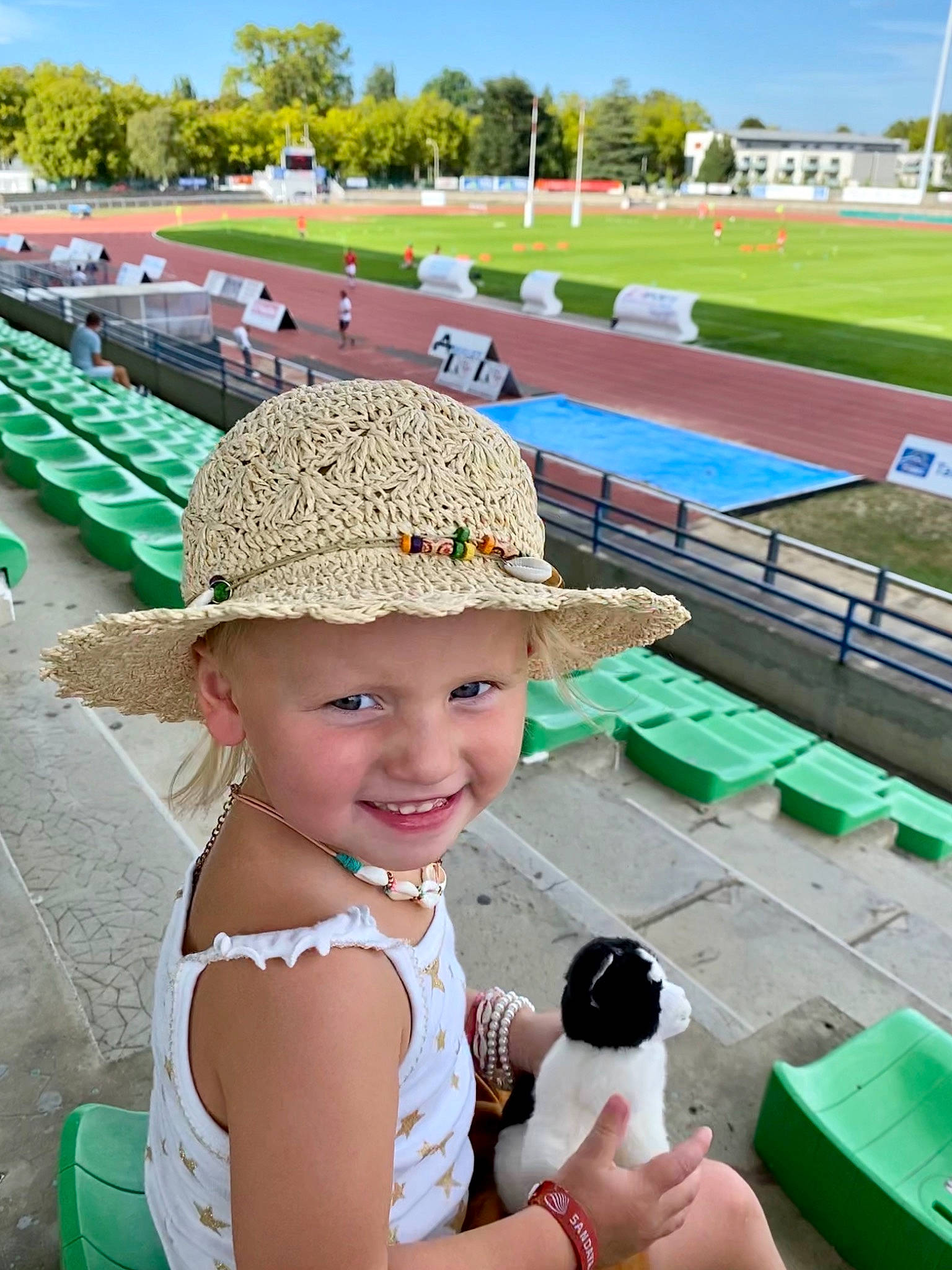 Emma participe au concours pour gagner de l'argent avec cette photo : baseball_cap, cap, fun, grass, green, happy, hat, headwear, joy, leisure, mammal, outdoor_furniture, person, product, recreation, sky, smile, summer, sun_hat, toddler