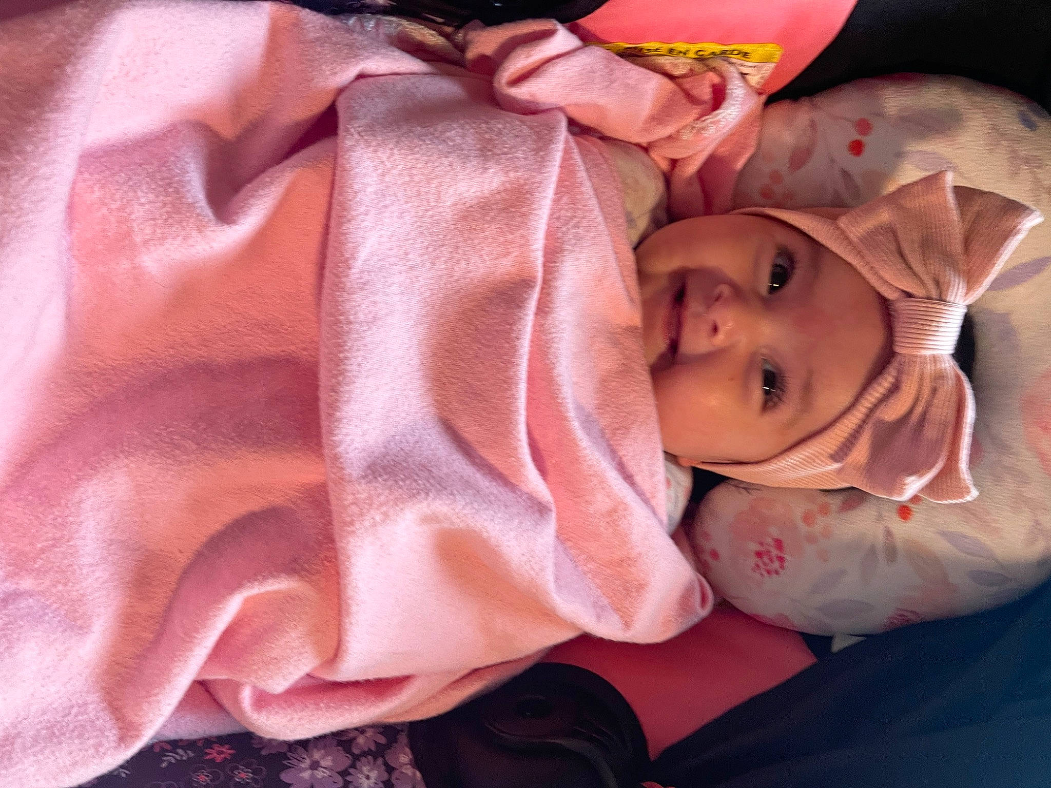 Madeline is registered to the contest to win money with this photo: baby, baby_products, baby_toddler_clothing, carmine, cheek, child, comfort, dress, fashion_accessory, fur, happy, hat, headwear, linens, magenta, nail, peach, person, pink, smile