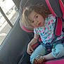 blue_pants, car_interior, car_seat, casual_clothing, child, curly_hair, daylight, gray, parking_lot, person, pink, road, safety, sandal, seat, seatbelt, toddler, vehicle, window, young_child