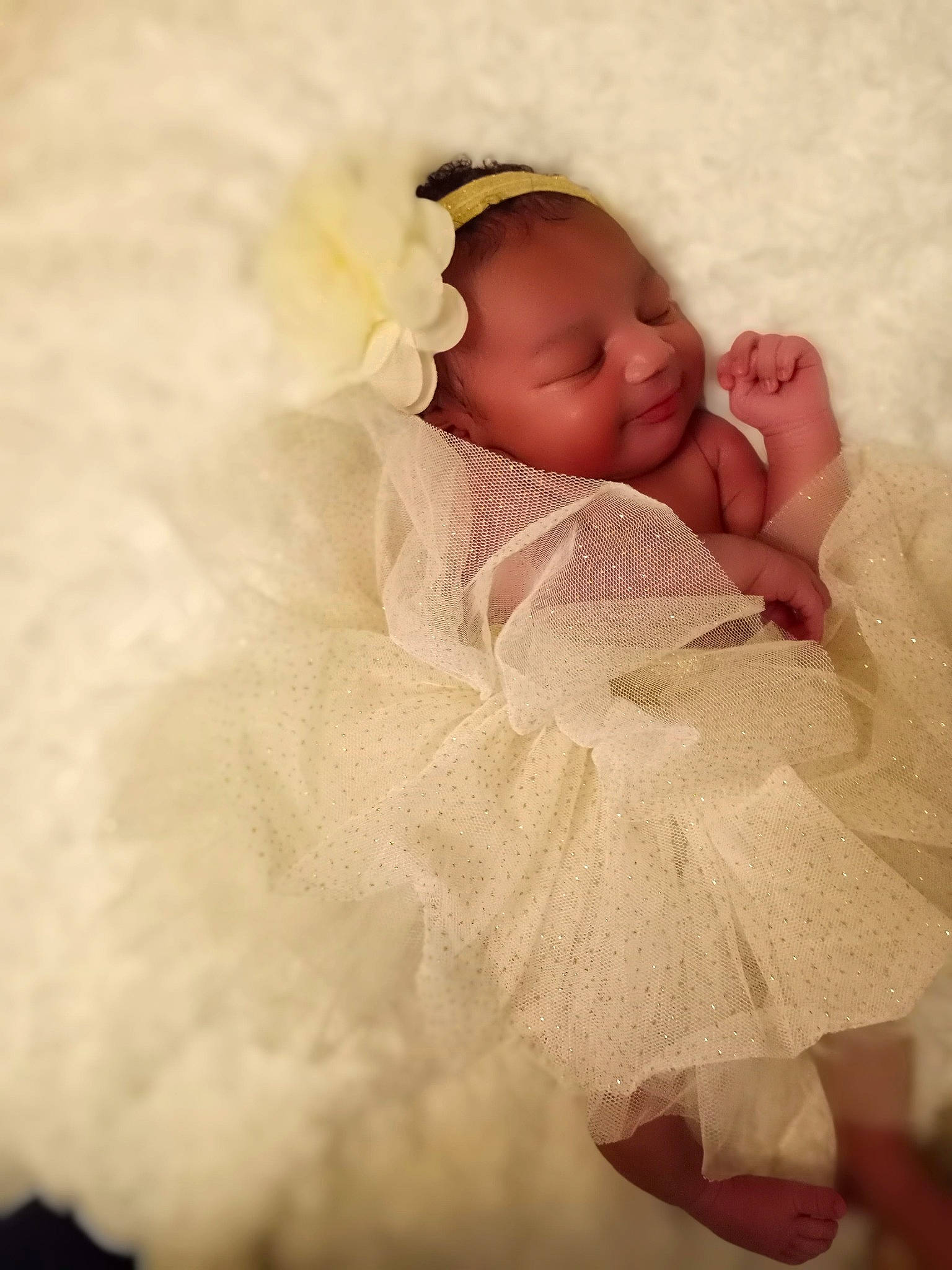 Ca'Miyah is registered to the contest to win money with this photo: arm, baby, baby_sleeping, baby_toddler_clothing, bed, bedding, bedtime, bridal_accessory, comfort, dress, event, flash_photography, hand, happy, linens, lip, peach, person, room, textile