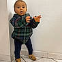 toddler, child, standing, plaid_jacket, navy_leggings, brown_shoes, indoor, tile_floor, white_wall, curious, young_child, person, small_child, portrait, casual_clothing, cute, baby, exploring, corner, home