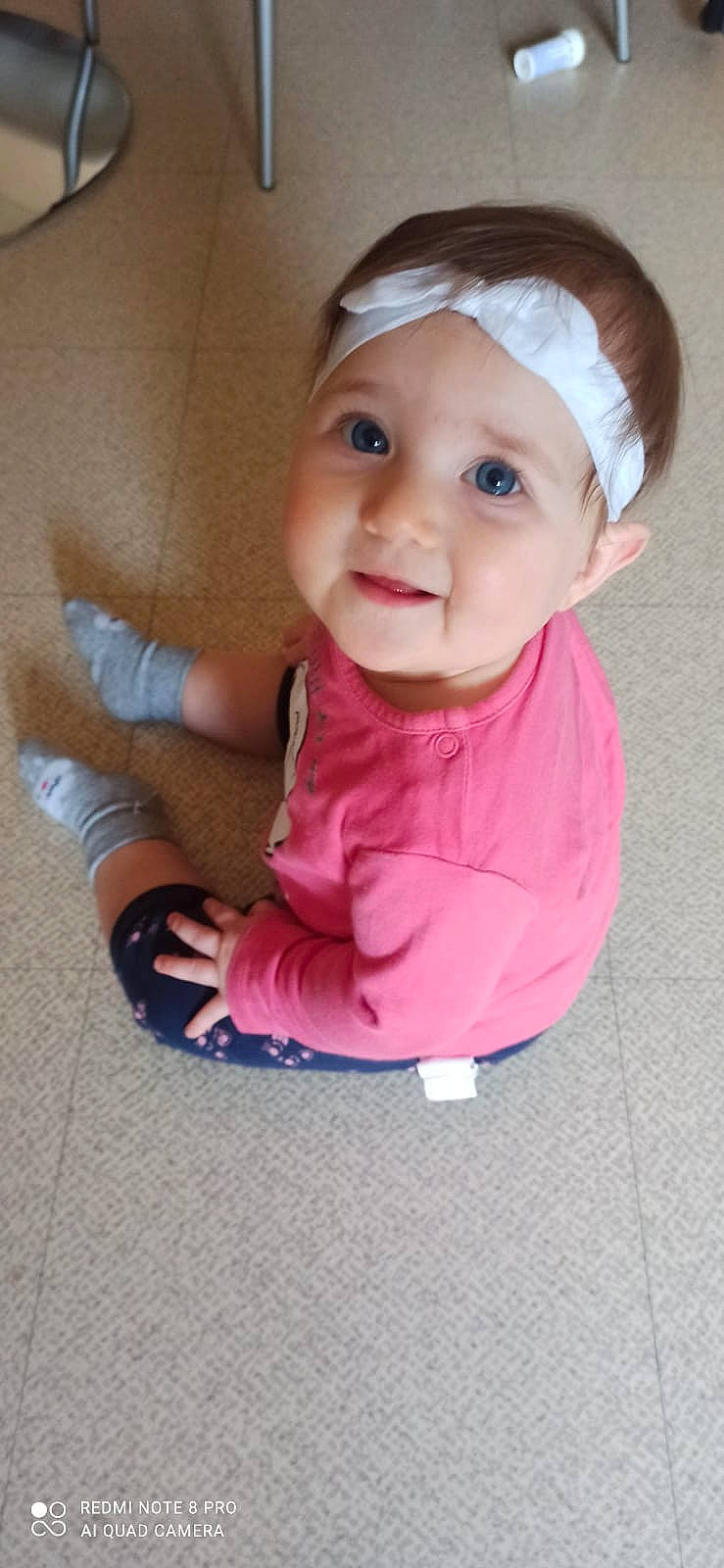 Lilyana participe au concours pour gagner de l'argent avec cette photo : baby, baby_products, baby_toddler_clothing, cheek, child, chin, eye, eyelash, fashion_accessory, fun, headwear, lip, magenta, nose, person, pink, sitting, skin, sleeve, smile