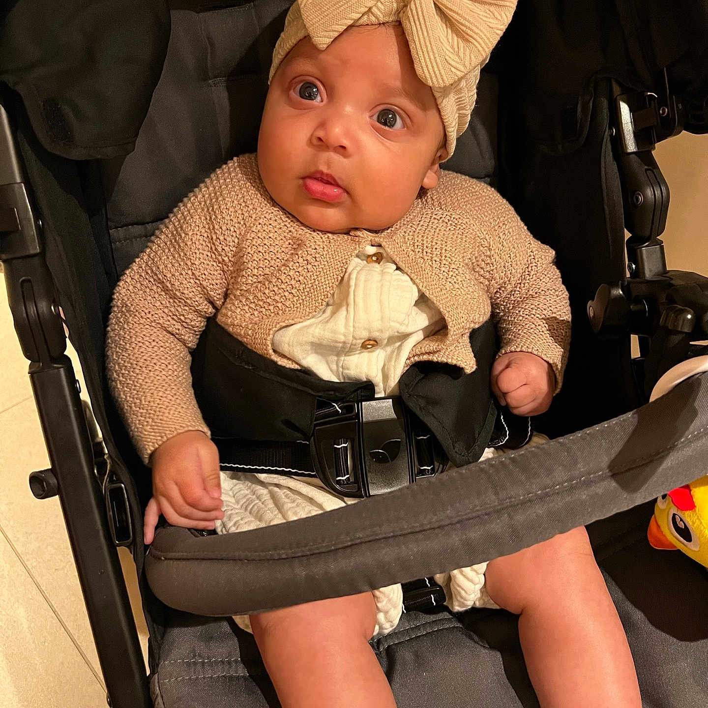 Kreed is registered to the contest to win money with this photo: accessories, baby, belt, cap, car, car_interior, carseat, clothing, face, hat, head, pants, person, photography, portrait, sitting, stroller, toy, transportation, vehicle