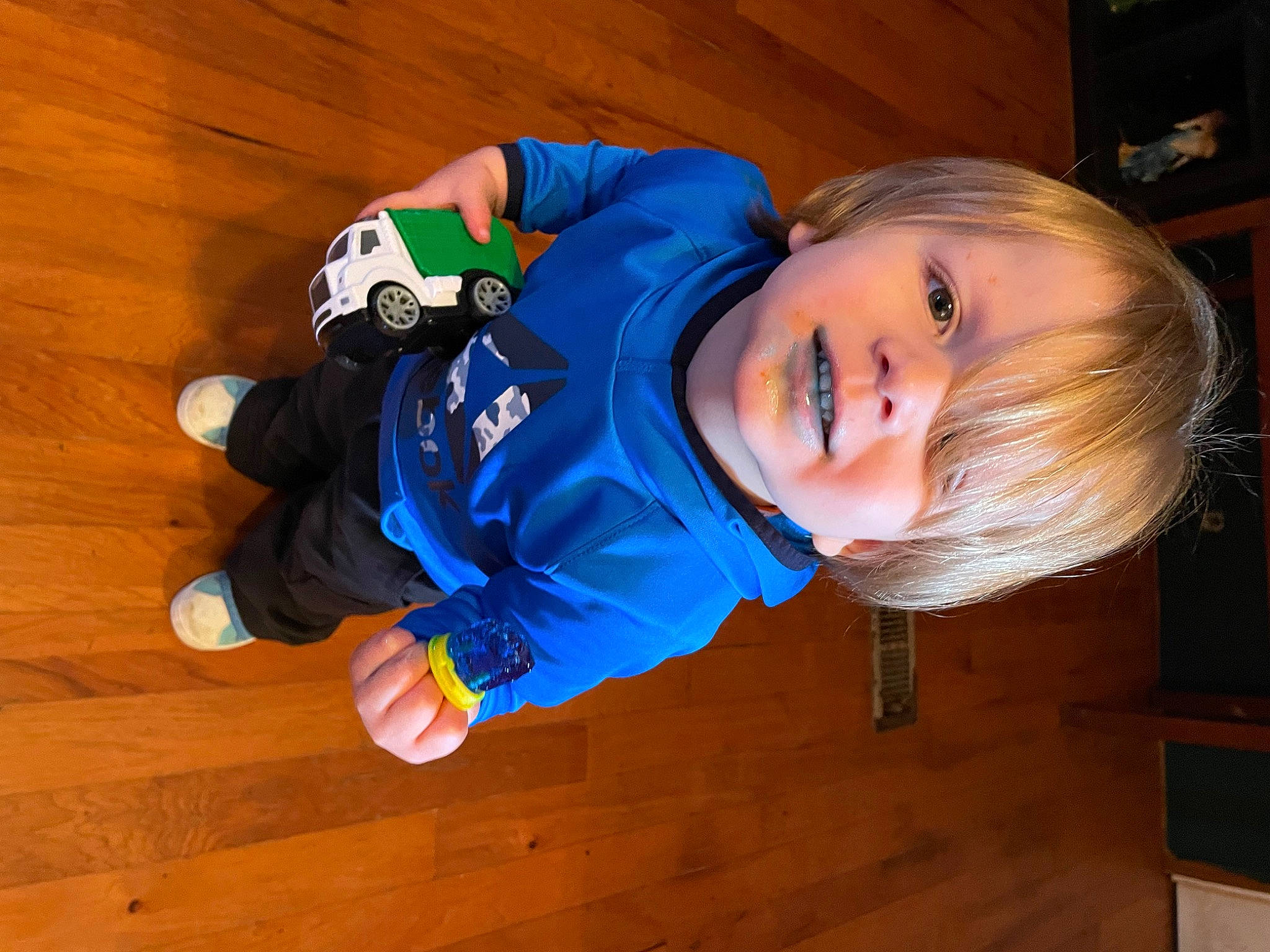 Kenneth is registered to the contest to win money with this photo: baby, baby_toddler_clothing, child, electric_blue, face, floor, flooring, fun, happy, hardwood, head, jacket, person, sitting, sleeve, smile, toddler, varnish, wood, wood_flooring