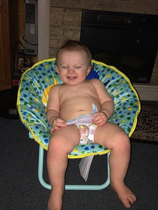 Brody is registered to the contest to win money with this photo: abdomen, baby, baby_toddler_clothing, barefoot, chair, chest, child, comfort, event, foot, fun, human_leg, joy, knee, lap, person, shorts, sitting, smile, thigh