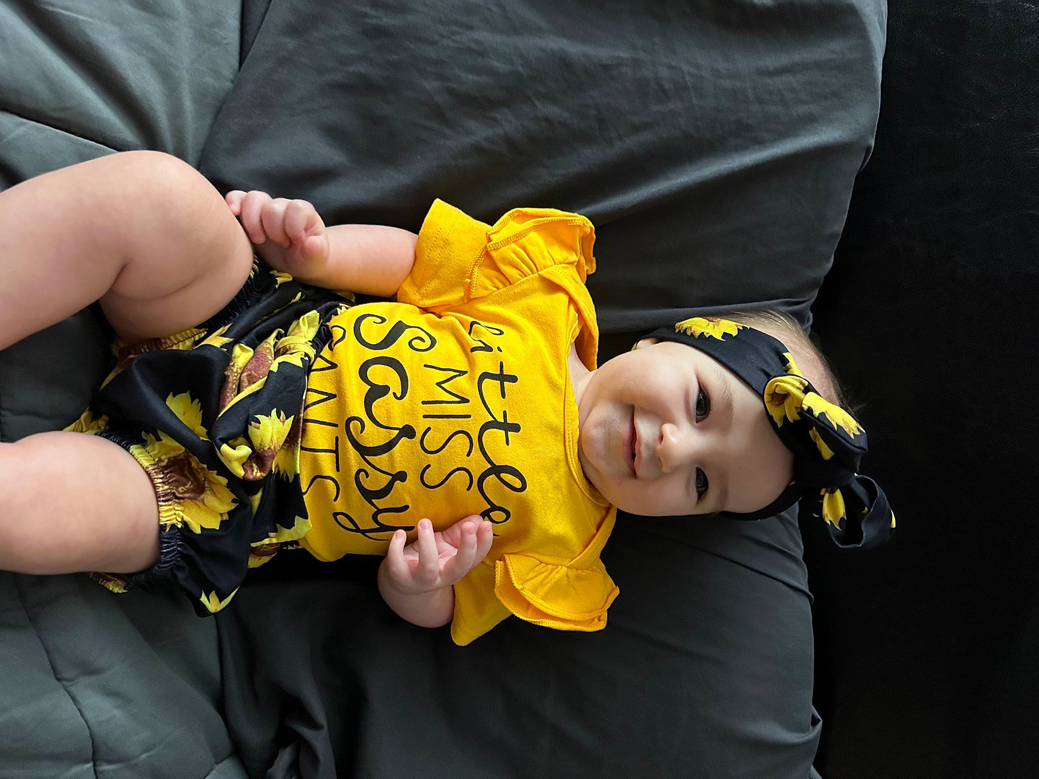 Charlotte joined the competition — help win amazing prizes! baby, baby_products, baby_toddler_clothing, child, comfort, event, eye, finger, fun, gesture, happy, headwear, human_body, joy, mammal, nail, person, sitting, smile, t_shirt