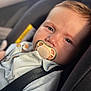 baby, pacifier, car_seat, child, infant, face, close_up, seatbelt, clothing, light, natural_light, portrait, cute, young_child, sitting, secure, safety, soft_focus, indoor, expression