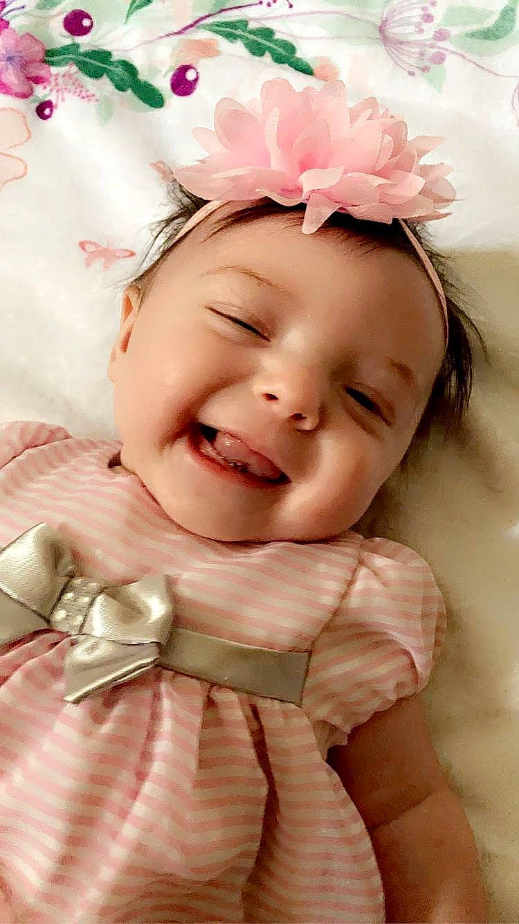 Alaiya is registered to the contest to win money with this photo: baby, baby_toddler_clothing, cheek, child, chin, eye, eyebrow, face, happy, head, headgear, headpiece, headwear, lip, magenta, person, petal, pink, skin, smile