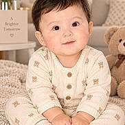 Asiya is registered to the contest to win money with this photo: baby, child, infant, portrait, smiling, sitting, indoor, nursery, teddy_bear, stuffed_animal, blanket, carpet, sweater, onesie, cream_clothing, flowers, bouquet, furniture, cozy, close_up
