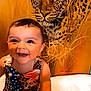 animal, baby, bodypart, cheetah, couch, face, finger, furniture, hand, happy, head, laughing, mouth, panther, person, photography, portrait, sitting, smile, teeth