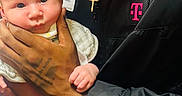 Donnie joined the competition — help win amazing prizes! baby, man, smiling, holding, infant, portrait, indoor, jacket, cross_necklace, skin, hand, face, person, clothing, expression, cute, toddler, human, love, t_mobile_logo