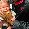 baby, man, smiling, holding, infant, portrait, indoor, jacket, cross_necklace, skin, hand, face, person, clothing, expression, cute, toddler, human, love, t_mobile_logo
