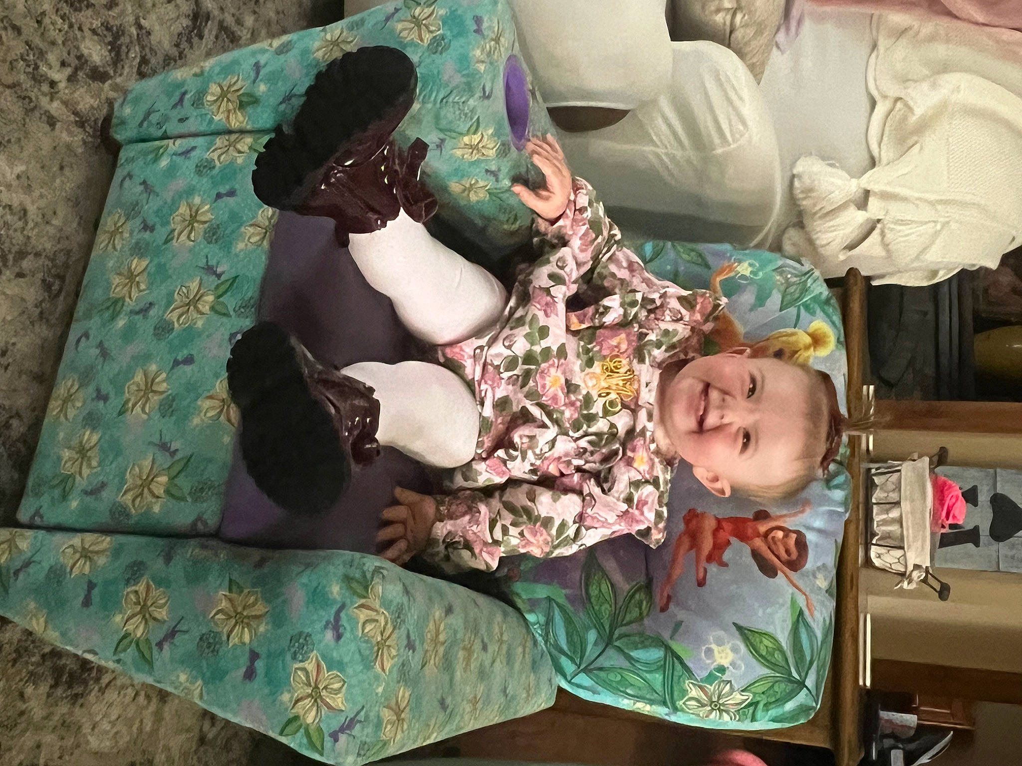 Maci joined the competition — help win amazing prizes! baby, baby_products, baby_toddler_clothing, child, comfort, green, joy, lap, linens, pattern, person, room, sitting, smile, textile, toddler, wood