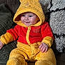 Elijah joined the competition — help win amazing prizes! baby, child, couch, cozy, cute, face, footwear, fuzzy_clothing, hand, happy, hood, indoors, infant, onesie, pillow, plush, seated, smile, soft_toys, winnie_the_pooh