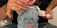 Elijah joined the competition — help win amazing prizes! baby, adult, denim_overall, hat, marvel, spiderman, smile, happy, indoor, couch, tattoo, hand_holding, child, person, clothing, casual, jeans, facial_hair, beard, seated