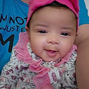 Winnie is registered to the contest to win money with this photo: baby, child, smiling, headband, pink, floral, clothing, person, portrait, closeup, cute, infant, happy, ruffles, fabric, human, face, indoors, apparel, holding