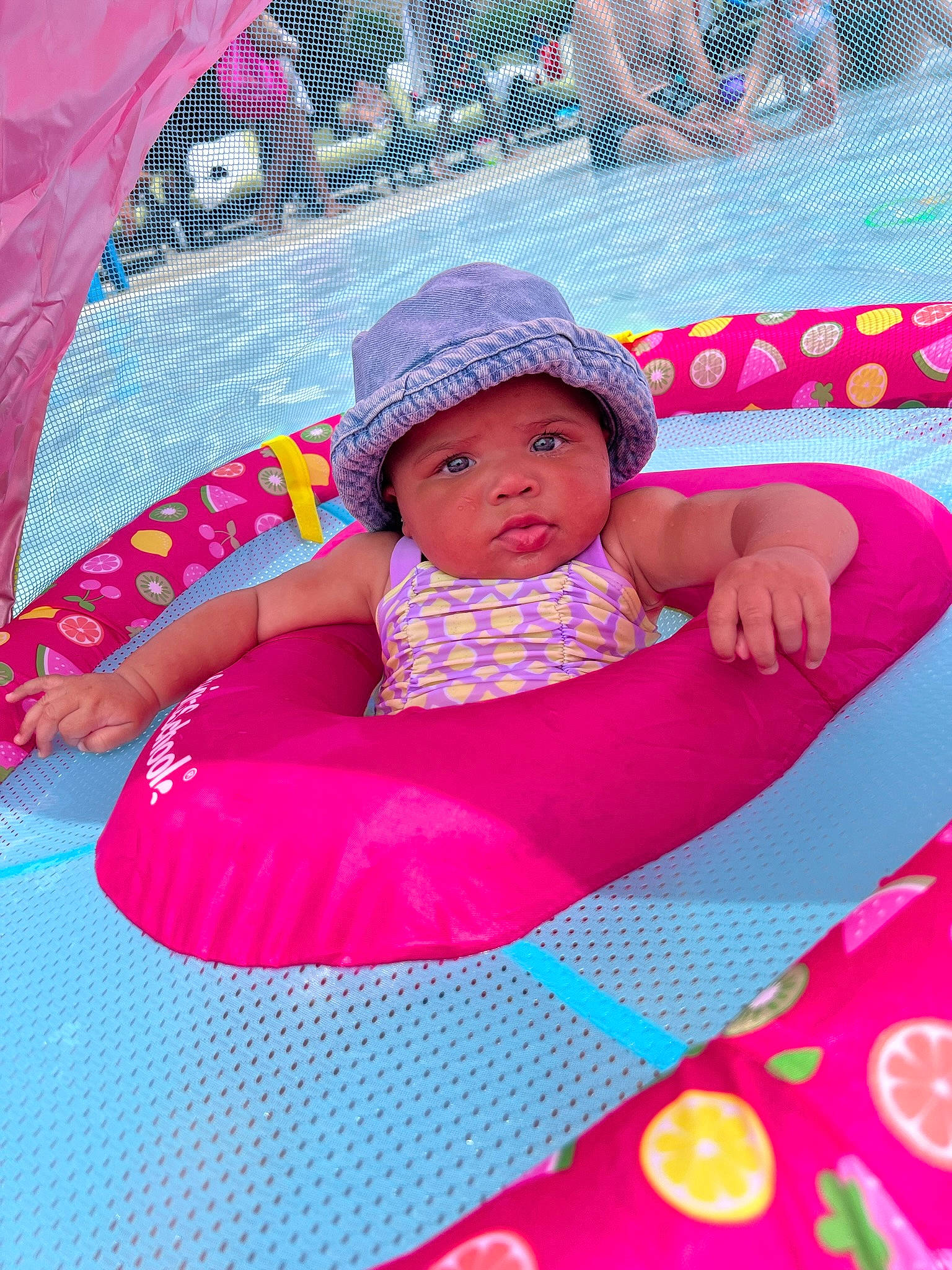 Emmy joined the competition — help win amazing prizes! baby, baby_toddler_clothing, cap, child, comfort, facial_expression, fun, grass, happy, hat, headwear, lap, leisure, magenta, person, pink, purple, recreation, red, skin