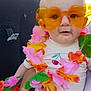 Cataleya a rejoint le concours — aidez-le/la à gagner de superbes lots ! accessories, baby, child, cute, flower_lei, grass, green_leaves, hand, heart_shaped, infant, orange_glasses, outdoor, person, pink_flowers, portrait, smiling, summer, sunglasses, white_outfit, yellow_flowers