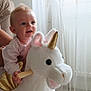 Cataleya participe au concours pour gagner de l'argent avec cette photo : baby, child, cozy, curtains, floor, foot, furniture, hand, happy, indoor, light, person, plush_toy, rocking_horse, smiling, soft, support, toy, unicorn, window