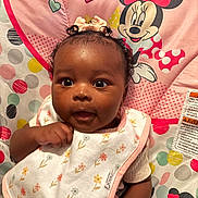 Rheyna joined the competition — help win amazing prizes! baby, infant, child, portrait, wide_eyes, curly_hair, smiling, sitting, bib, floral_pattern, pink, minnie_mouse, cushion, bed, indoor, close_up, looking_at_camera, adorable, colorful, baby_clothing
