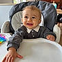 Maé a rejoint le concours — aidez-le/la à gagner de superbes lots ! baby, high_chair, smiling, indoor, child, happy, person, white_tray, clothing, long_sleeves, furniture, window, daylight, hand, face, cute, young_child, table, toy, home
