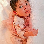 Andrea Camila is registered to the contest to win money with this photo: adorable, baby, blanket, child, close_up, cozy, curious_expression, cute, face, indoor, infant, lying_down, newborn, pink_clothing, portrait, resting, sleepwear, small_hands, soft_texture, warm