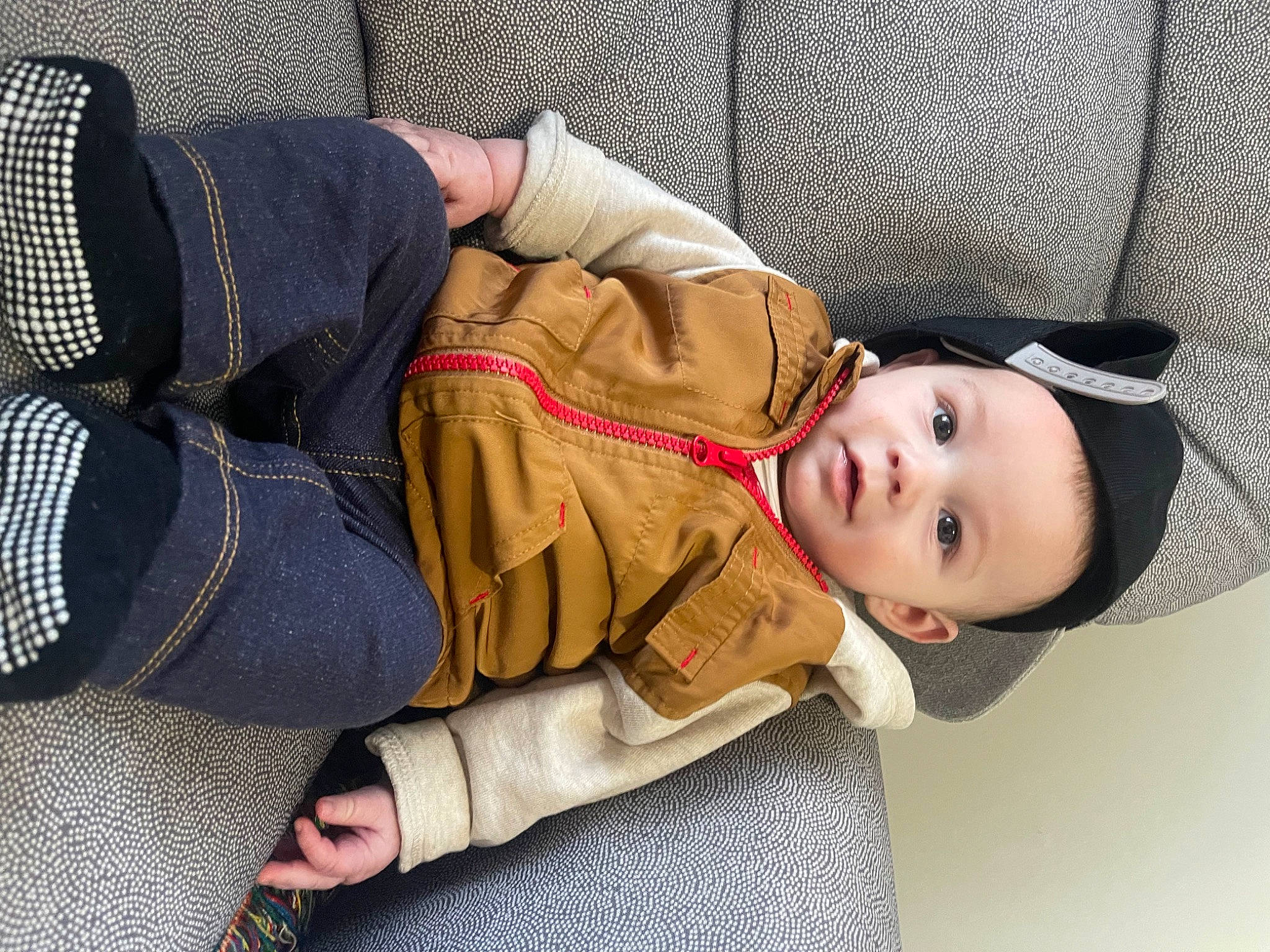 Bentlee is registered to the contest to win money with this photo: baby, child, comfort, fashion_accessory, flooring, fur, headwear, human_body, human_leg, joint, knee, leg, nap, outerwear, pattern, person, sitting, street_fashion, textile, thigh