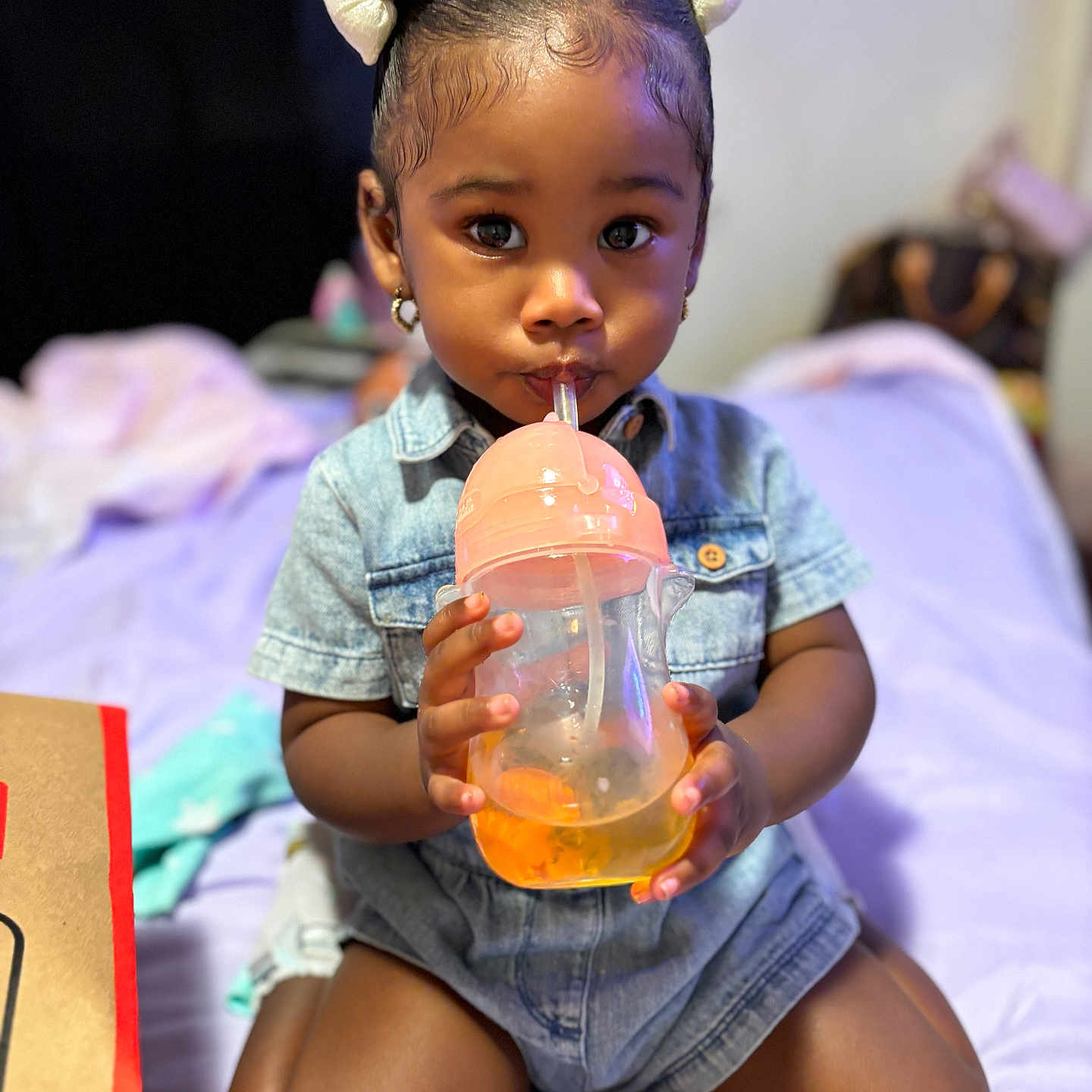 Kharlie is registered to the contest to win money with this photo: baby, beverage, bodypart, bottle, clothing, face, finger, hand, happy, hardwood, head, juice, person, photography, portrait, shaker, shorts, sitting, smile, sphere