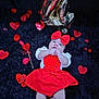 baby, infant, red_bow, red_dress, valentine_theme, glitter_hearts, rose_petals, gold_balloon, black_rug, lying_down, portrait, cute, adorable, hand_in_mouth, celebration, sparkle, soft_texture, plush_background, pink_cheeks, holiday_photo