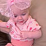 Dorothea is registered to the contest to win money with this photo: adorable, apparel, baby, candid, child, closeup, cute, hand, happy, headwear, indoor, infant, lace_bow, person, pink_clothing, portrait, sitting, smiling, soft_lighting, young_child
