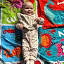 Dorothea is registered to the contest to win money with this photo: baby, bib, carpet, cartoon_animals, child, colorful, crab, cute, dots, fabric, happy, indoors, infant, lying_down, octopus, patterned_clothing, playmat, seahorse, smiling, whale
