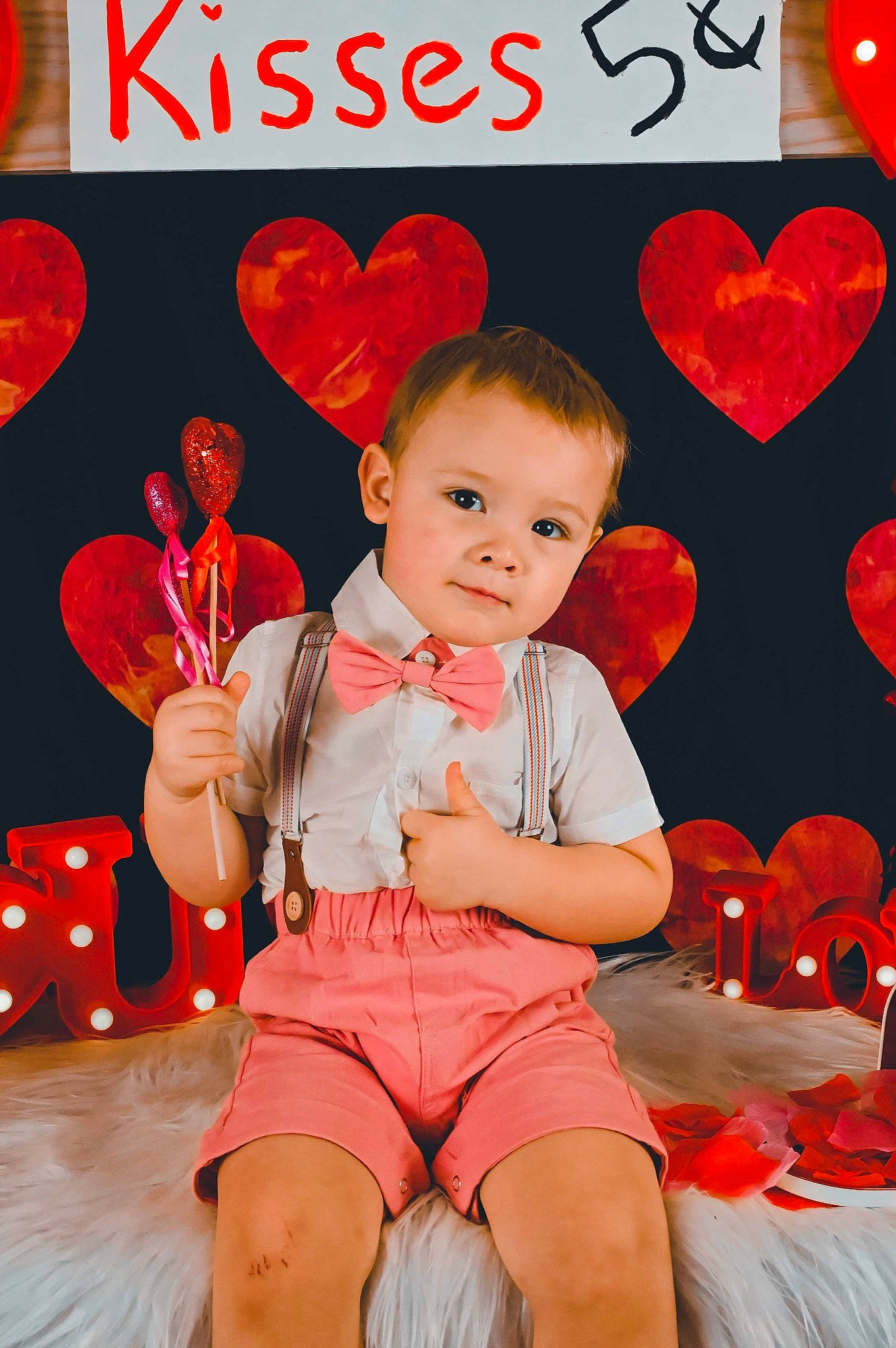 Kamryn is registered to the contest to win money with this photo: baby_toddler_clothing, chair, child, event, font, foot, happy, heart, holiday, human_leg, knee, lap, orange, organ, person, red, shorts, sitting, sock, thigh