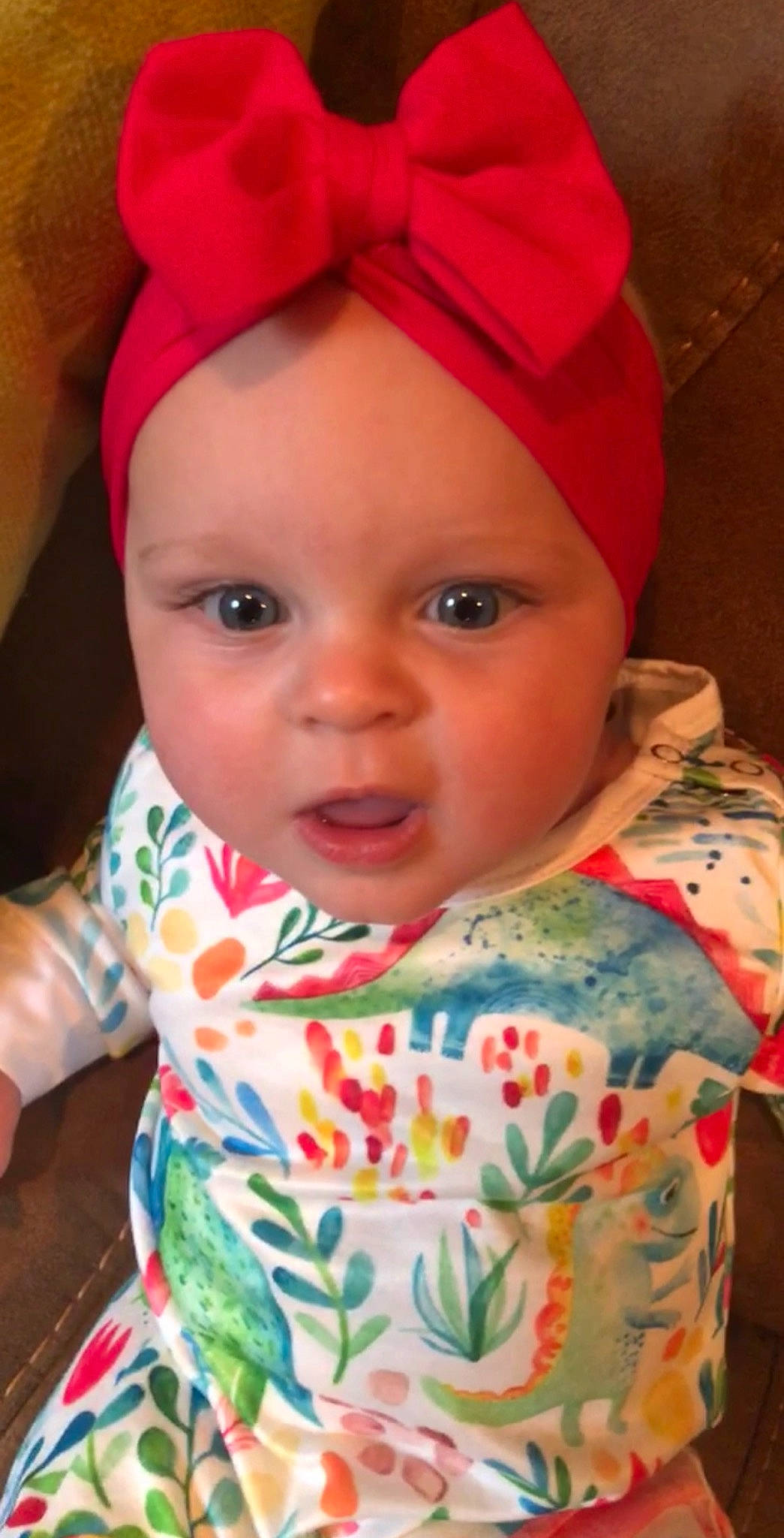 Leighton is registered to the contest to win money with this photo: baby, bonnet, cheek, child, ear, eye, face, fashion_accessory, forehead, hair_accessory, head, headband, headgear, headwear, lip, nose, person, pink, play, skin