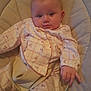 Paisley joined the competition — help win amazing prizes! baby, infant, child, pajamas, cushion, seat, hand, face, eyes, expression, clothing, comfort, indoor, person, cute, curious, soft, relaxed, young, resting