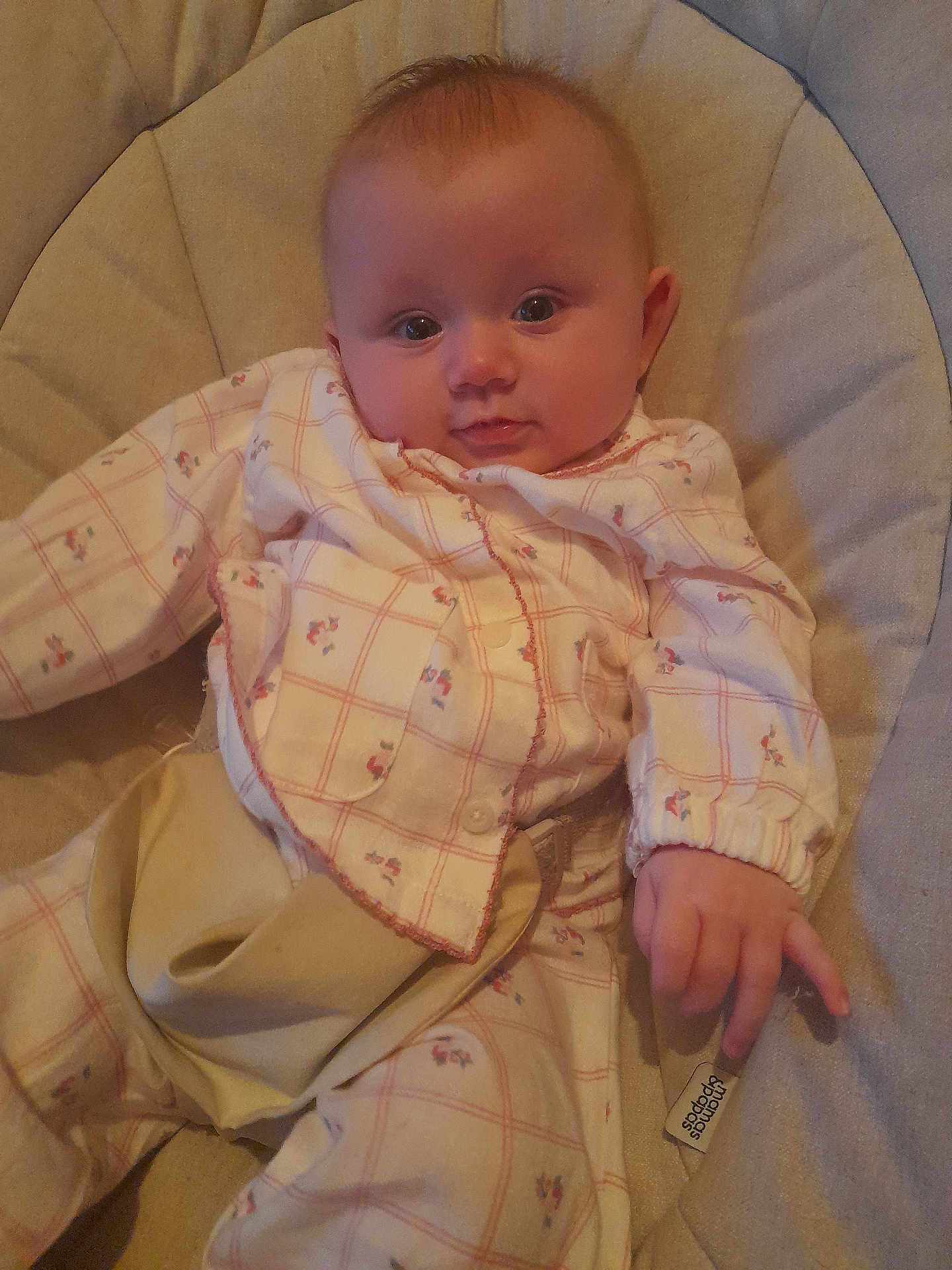 Paisley joined the competition — help win amazing prizes! baby, infant, child, pajamas, cushion, seat, hand, face, eyes, expression, clothing, comfort, indoor, person, cute, curious, soft, relaxed, young, resting