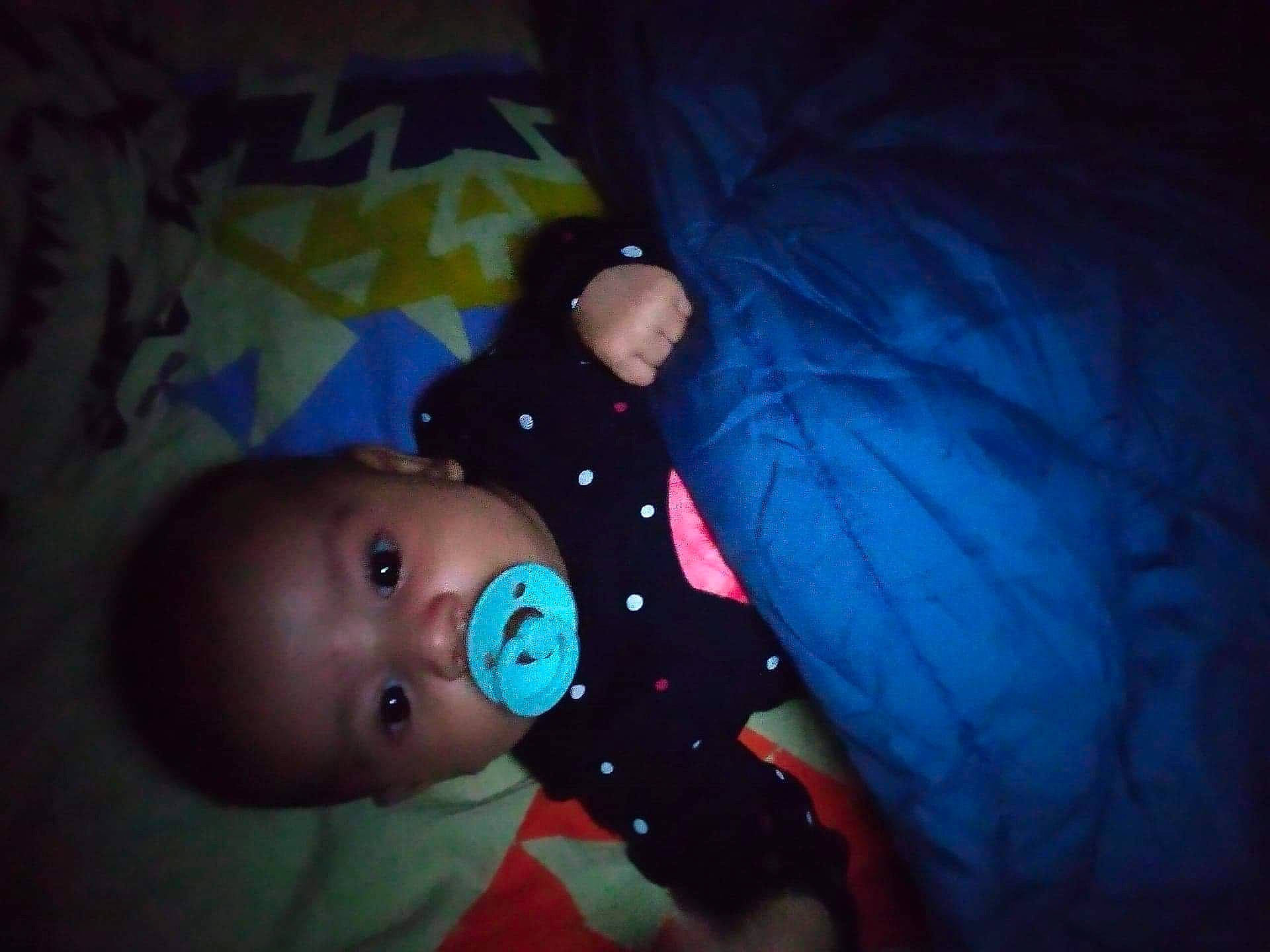 Brandon participe au concours pour gagner de l'argent avec cette photo : baby, baby_toddler_clothing, bedtime, cheek, child, comfort, darkness, electric_blue, flash_photography, fun, human_body, iris, linens, nose, person, room, sitting, space, tints_and_shades, toddler