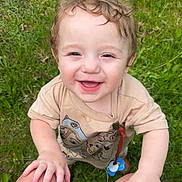 Alden is registered to the contest to win money with this photo: toddler, child, smiling, curly_hair, grass, outdoor, happy, baby, person, nature, greenery, clothing, pacifier, hands, legs, casual, cute, playing, summer, daylight
