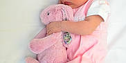 Lily is registered to the contest to win money with this photo: baby, newborn, sleeping, pink_clothing, stuffed_animal, bunny, soft_toy, blanket, infant, cute, peaceful, child, portrait, resting, toddler, bed, cozy, indoors, sleep, baby_girl