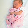 baby, newborn, sleeping, pink_clothing, stuffed_animal, bunny, soft_toy, blanket, infant, cute, peaceful, child, portrait, resting, toddler, bed, cozy, indoors, sleep, baby_girl