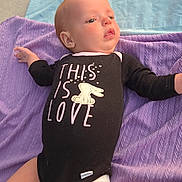 Aurora joined the competition — help win amazing prizes! baby, black_clothing, bunny_graphic, child, concrete, cute, diaper, expression, face, freckles, head, infant, legs, lying_down, onesie, outdoor, purple_blanket, small_hands, soft_light, text_on_clothing