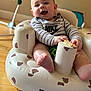 Jackson joined the competition — help win amazing prizes! baby, child, infant, smiling, happy, sitting, toy, onesie, nike, striped_clothing, inflatable_chair, teddy_bear_pattern, indoor, floor, wooden_floor, playtime, cute, face, hands, feet