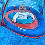 Jackson joined the competition — help win amazing prizes! baby, child, smiling, floating, swim_float, pool, water, blue, canopy, infant, outdoor, summer, recreation, fun, happy, person, sitting, clothing, white_shirt, splash